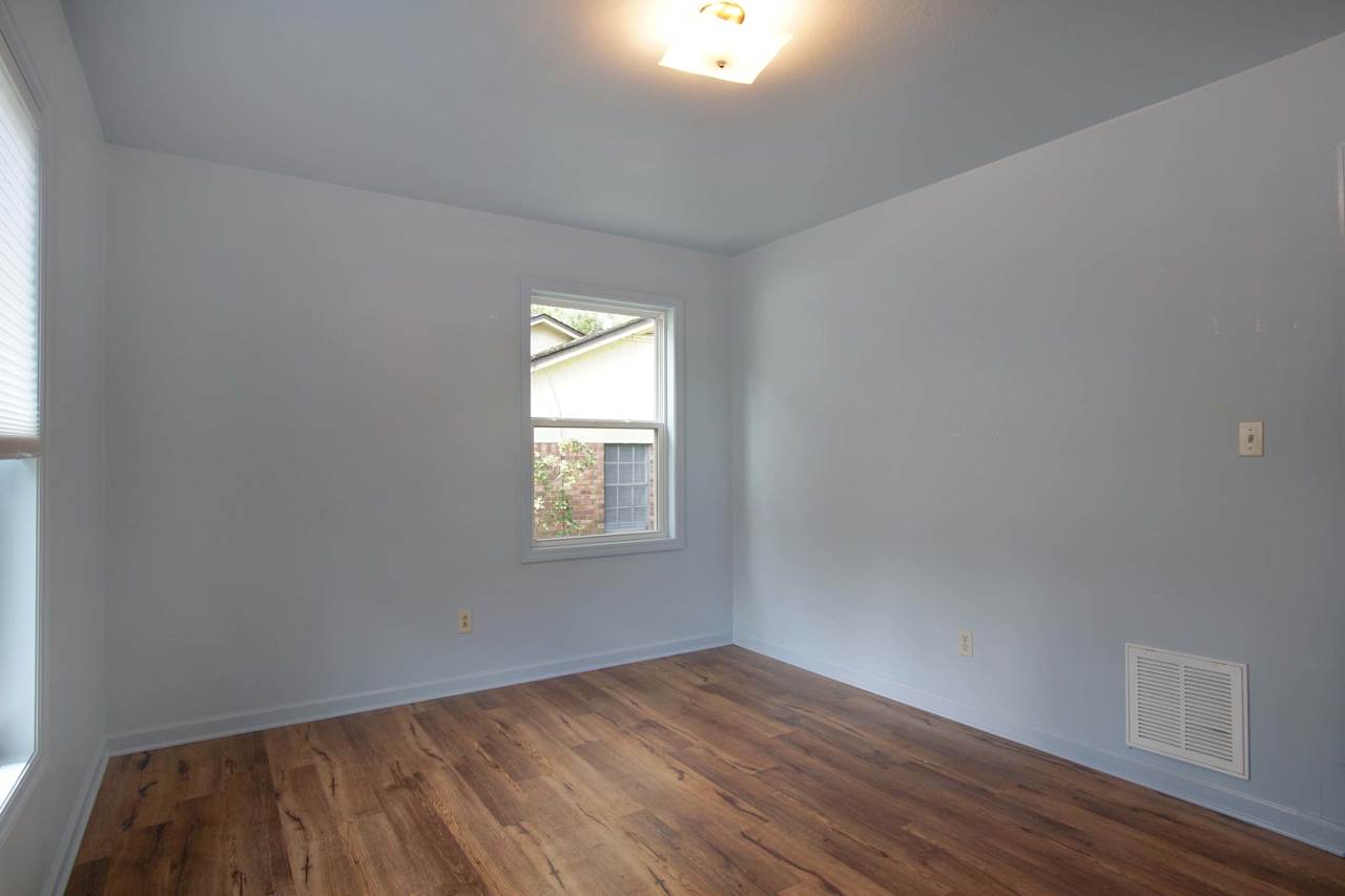 Photo of the third bedroom with lightly colored walls, plank flooring, at 1228 Winifred Drive, Tallahassee, Florida 32308