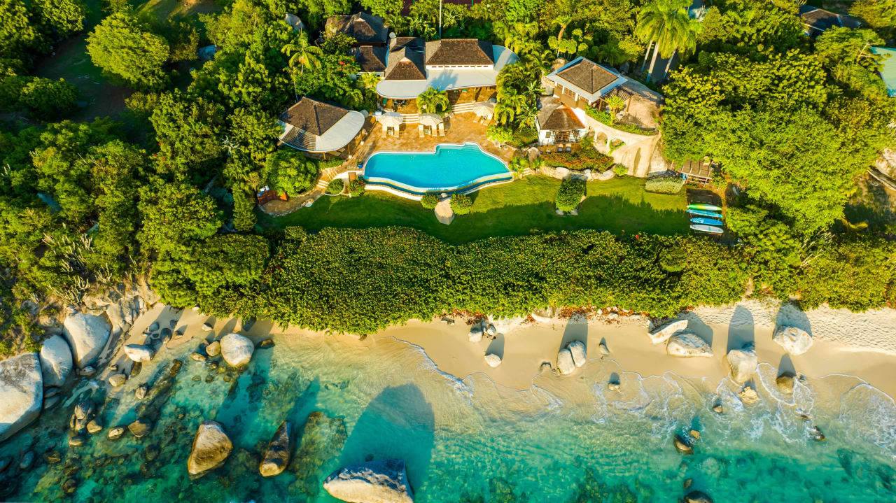 An aerial view of a villa on a beach