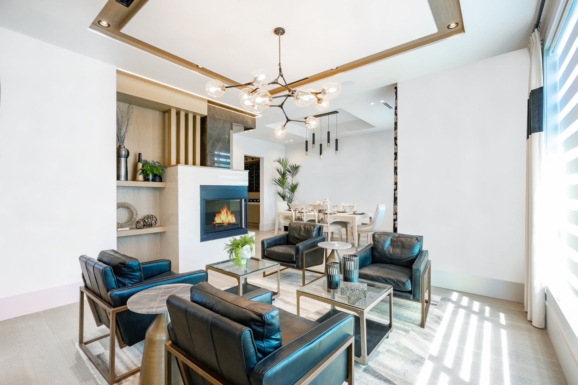 A luxurious and contemporary open-concept living space with a white color scheme.