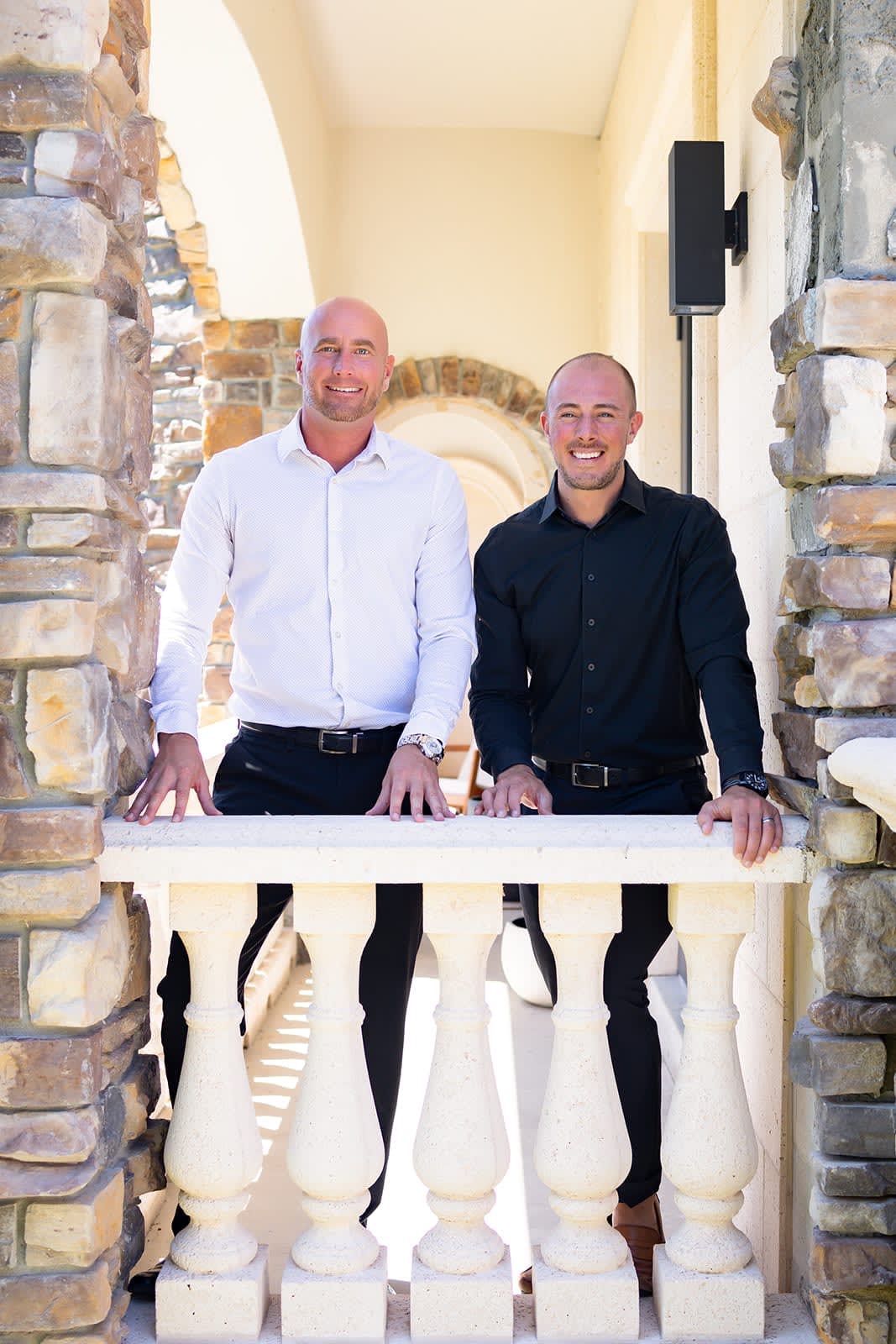 A portrait of Ryan Skrzypkowski and Derek McConnell on a porch.