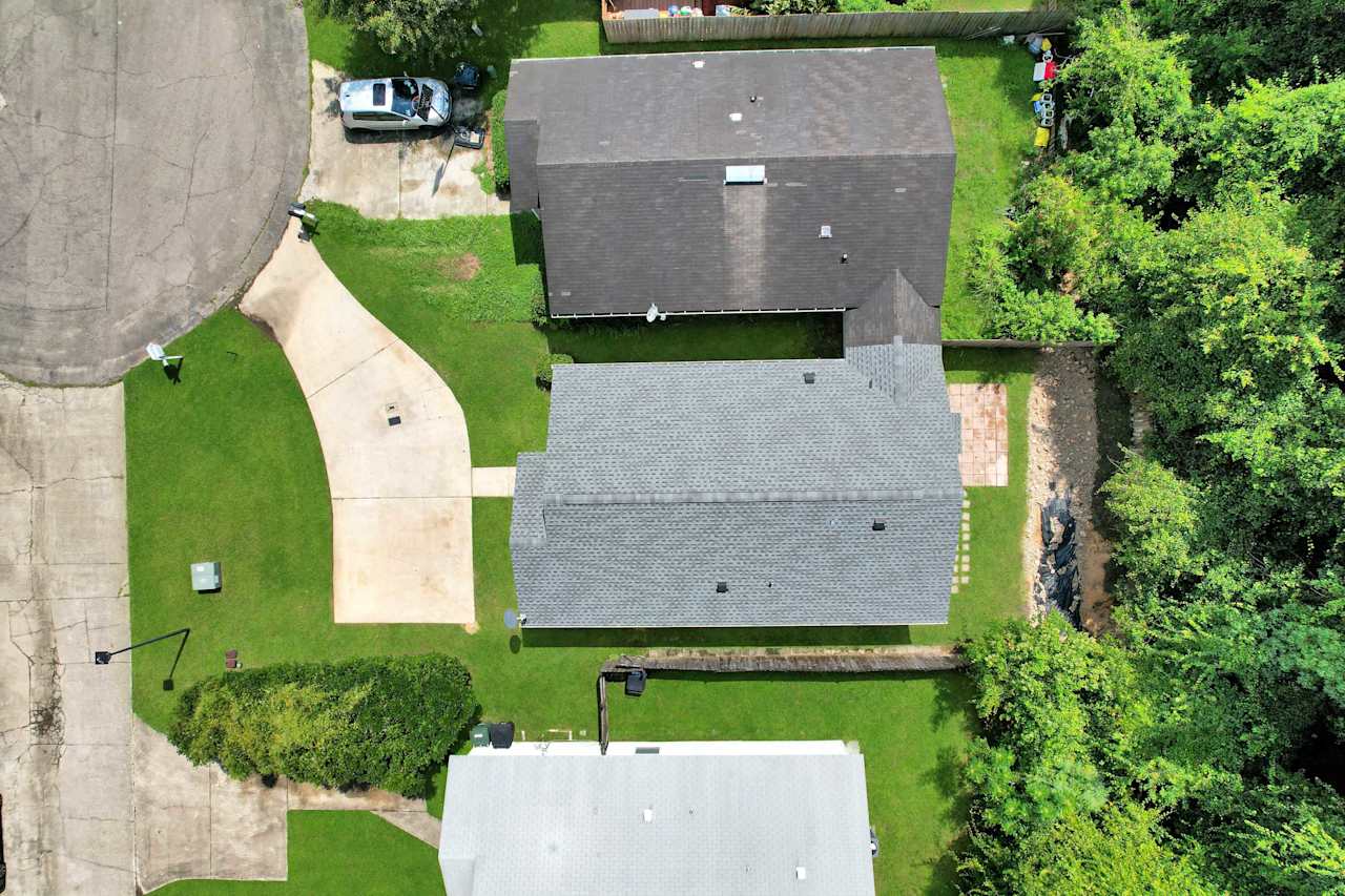 Drone or aerial photo of new roof, fenced yard, and semicircle driveway  at 2709 Oak Park Court, Tallahassee, Florida 32308