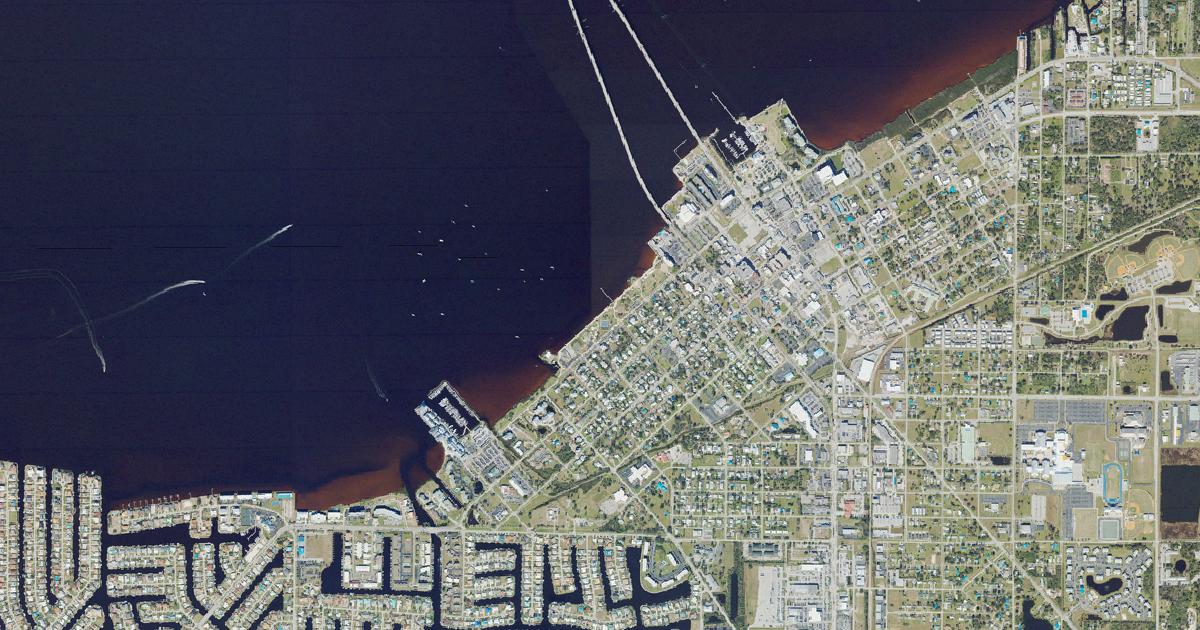 Aerial view of the Punta Gorda waterfront on Charlotte Harbor, showing the Fishermen's Village marina, the Laishley Court waterfront and the Punta Gorda Isles canals. USDA NAIP, 2023.