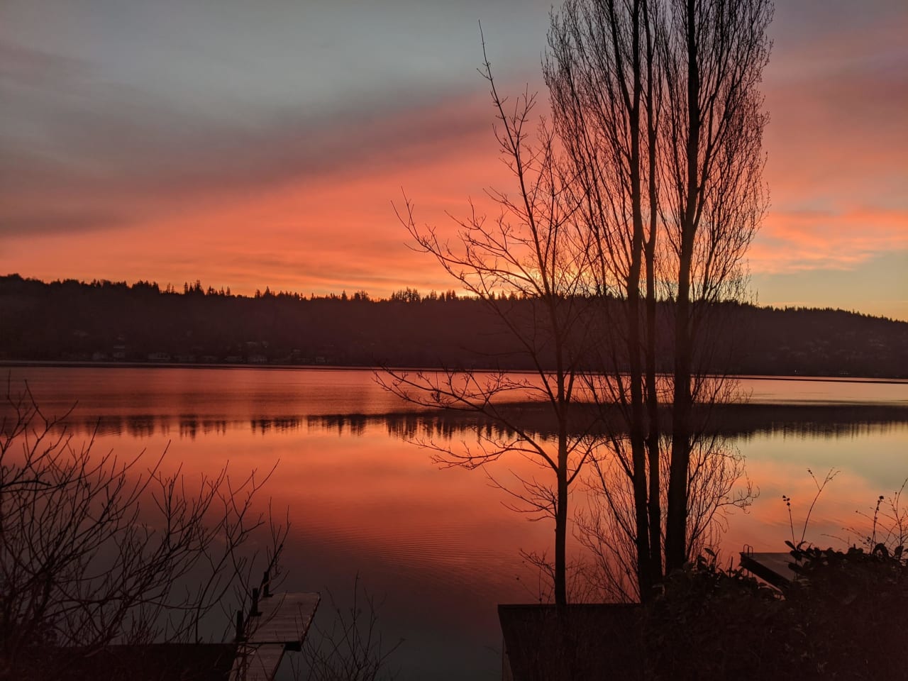 a red orange colored sunset on a lake