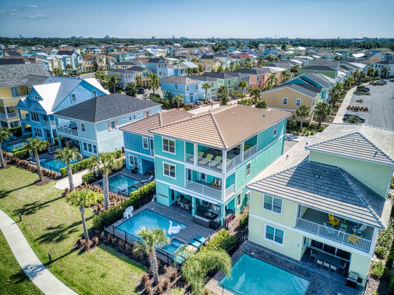 An aerial view of a row of colorful houses in a suburban neighborhood.