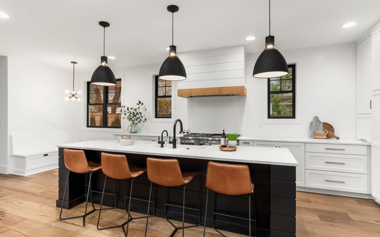 A modern kitchen with a large center island that has a sink on it.