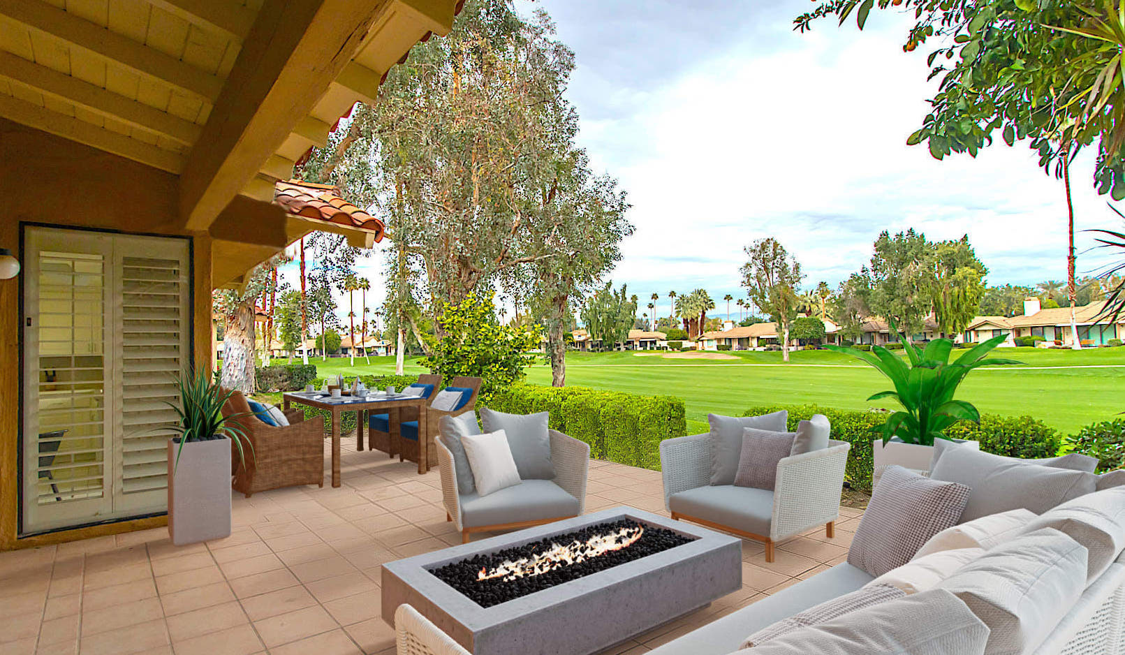 A modern patio with comfortable seating arranged around a fire pit