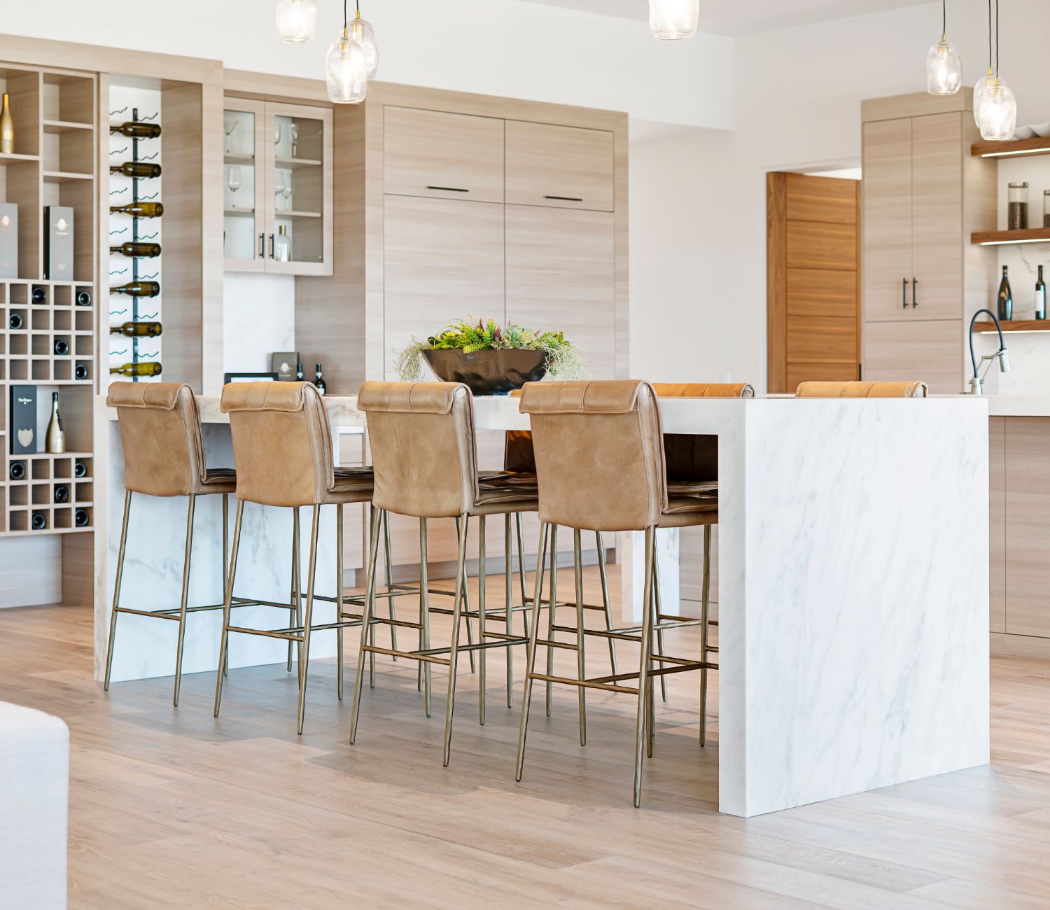 A kitchen with a bar and stools