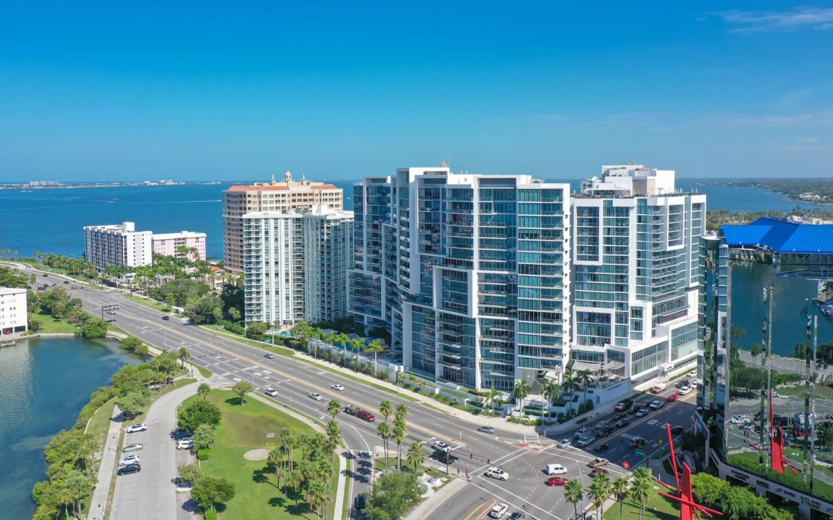 Aerial view of a large, modern building next to the ocean