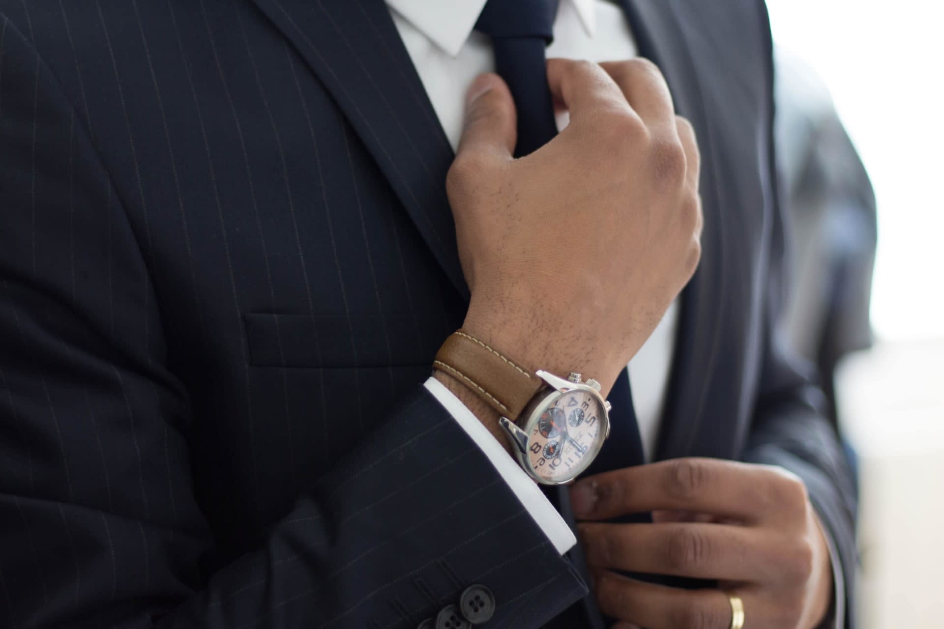 A business man holding his necktie