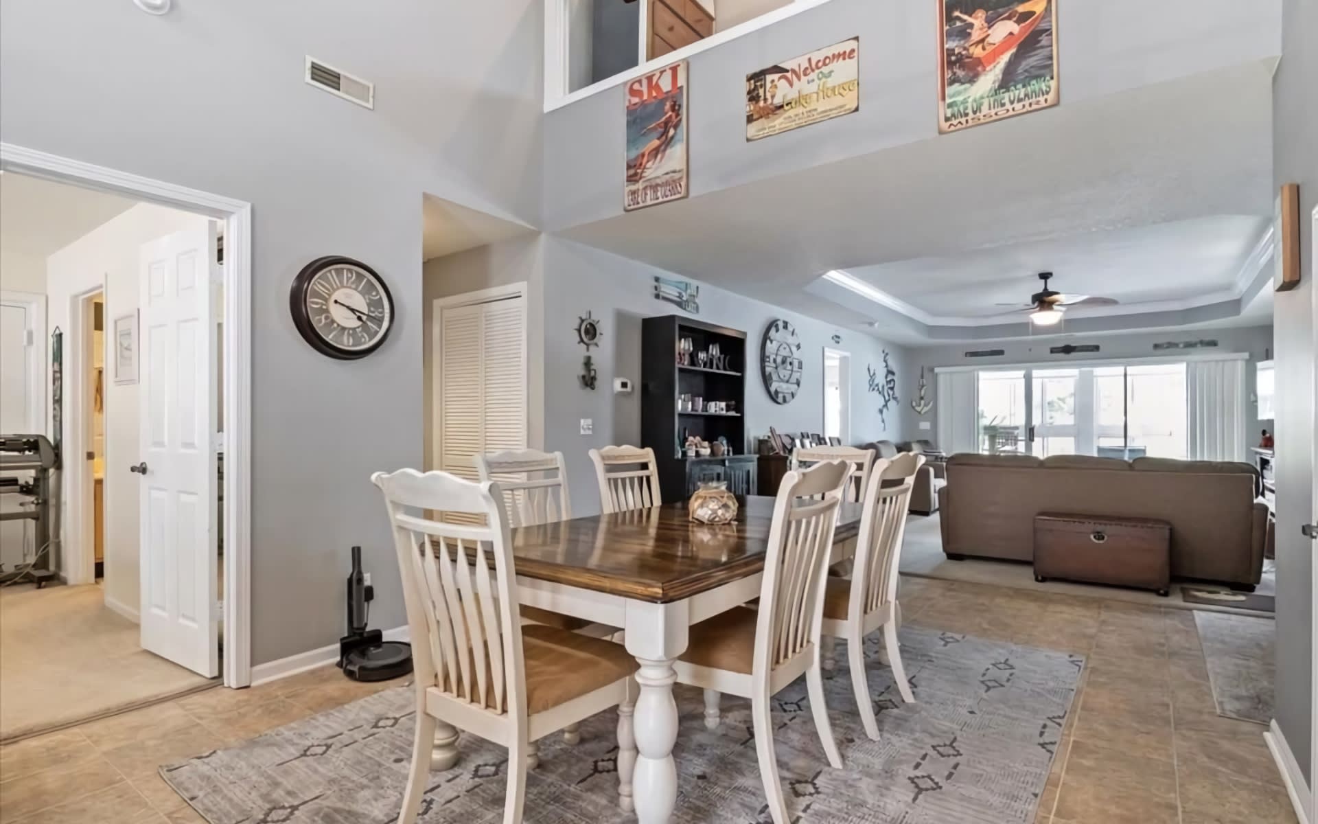 A spacious dining room with gray walls and a wooden dining table