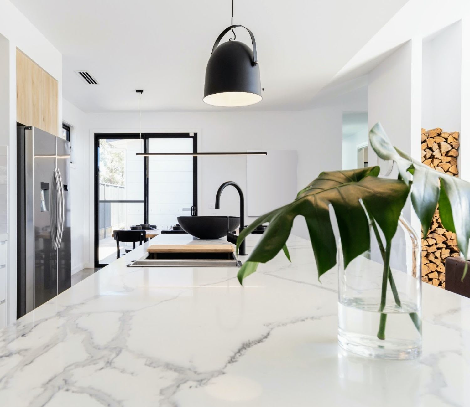 modern kitchen with marble counter top and a flower vase