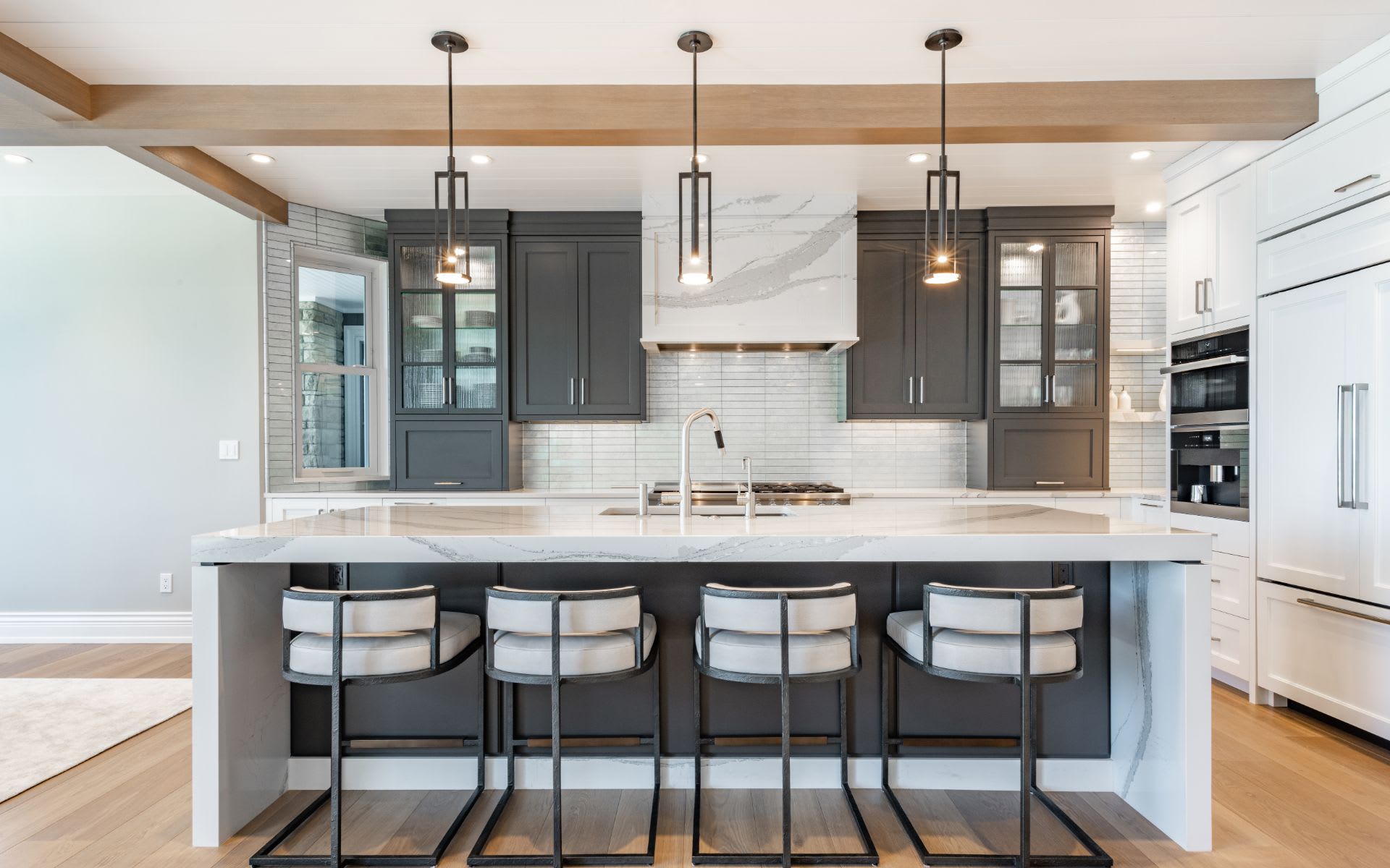 A modern kitchen with a spacious island and sleek stools