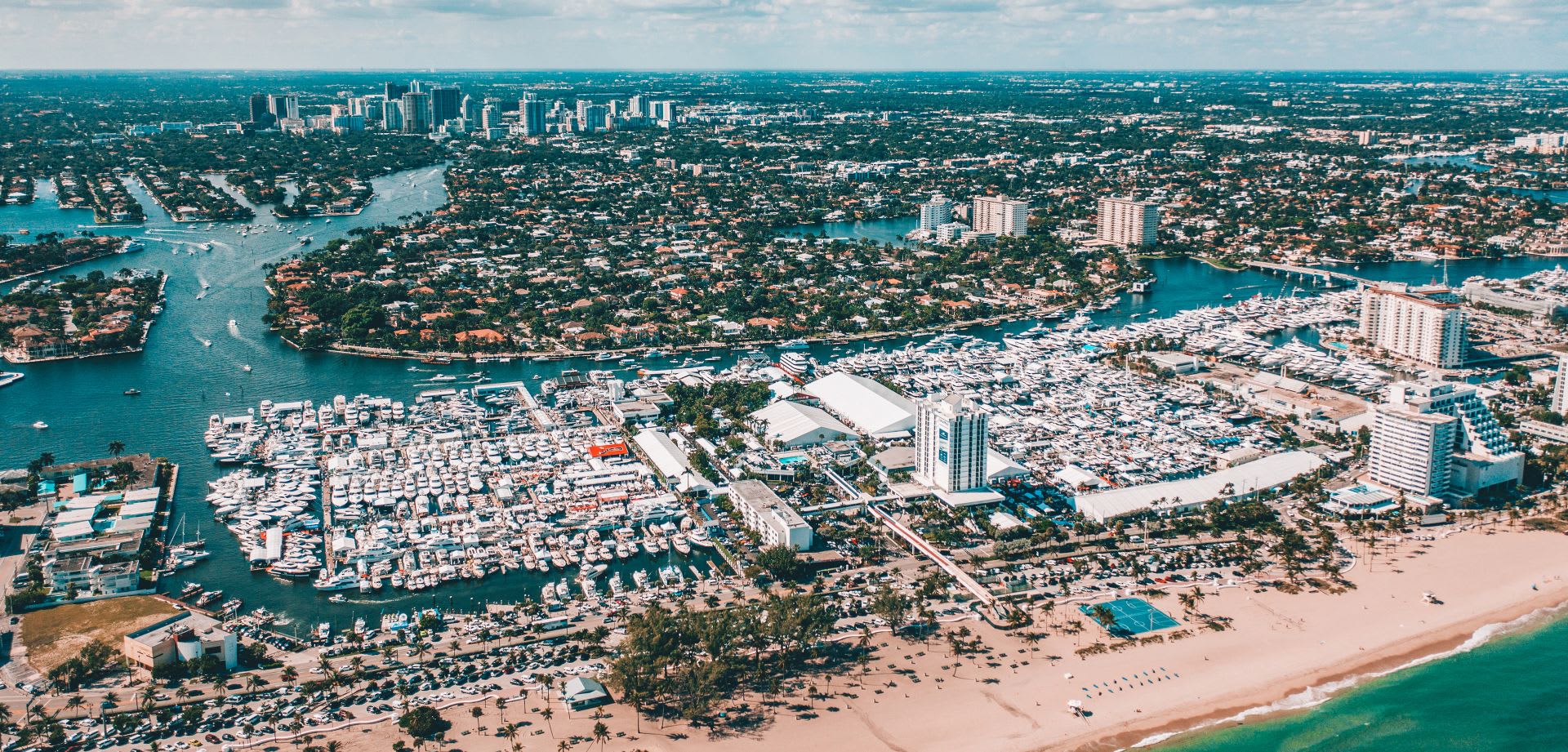 Aerial view of a city and a marina filled with boats of various sizes