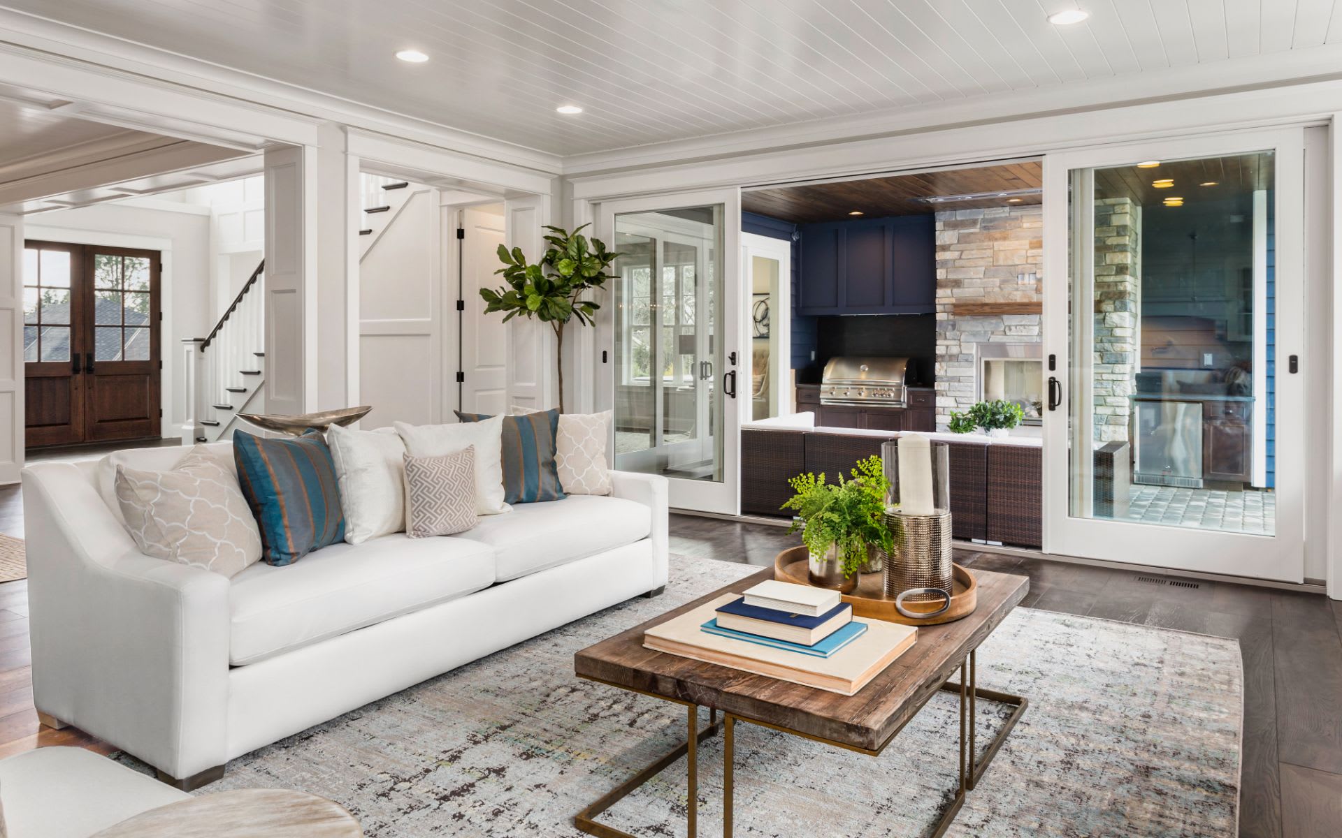 A modern living room with white walls and a white sofa