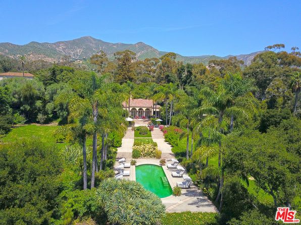 Luxury house with a pool in a lush green field