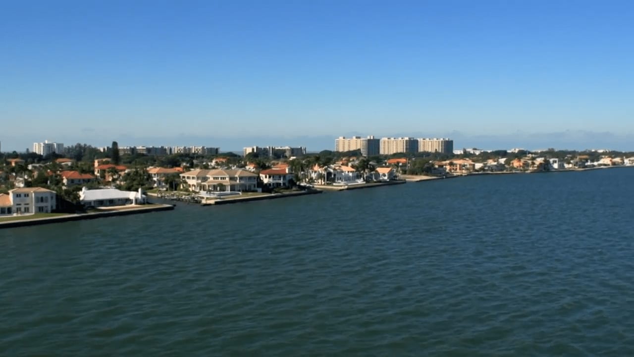 A fine blue sky and beautiful shore in Country Club Shores with  luxury homes and high-rise buildings