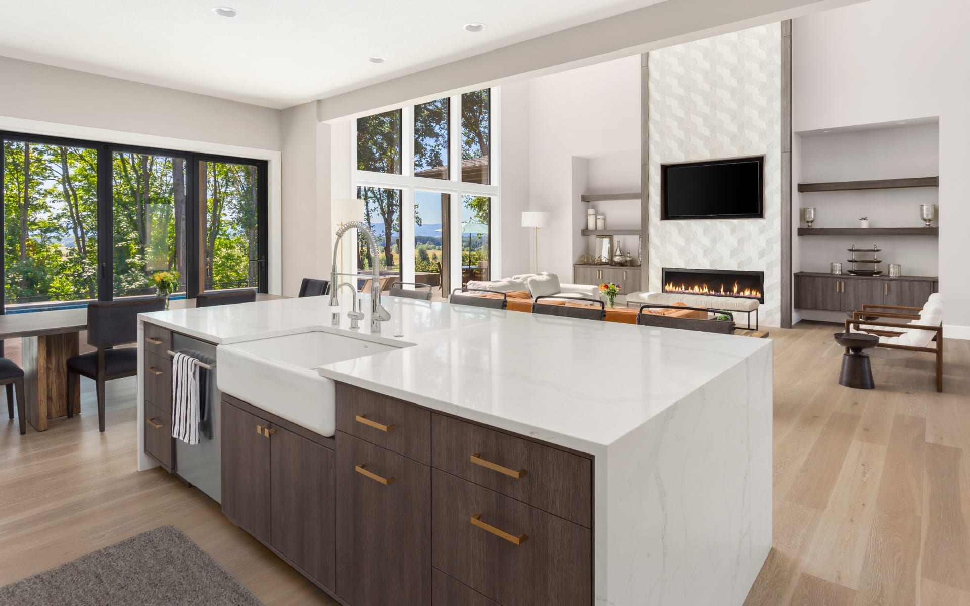 A kitchen with a sink, dishwasher, and a fireplace