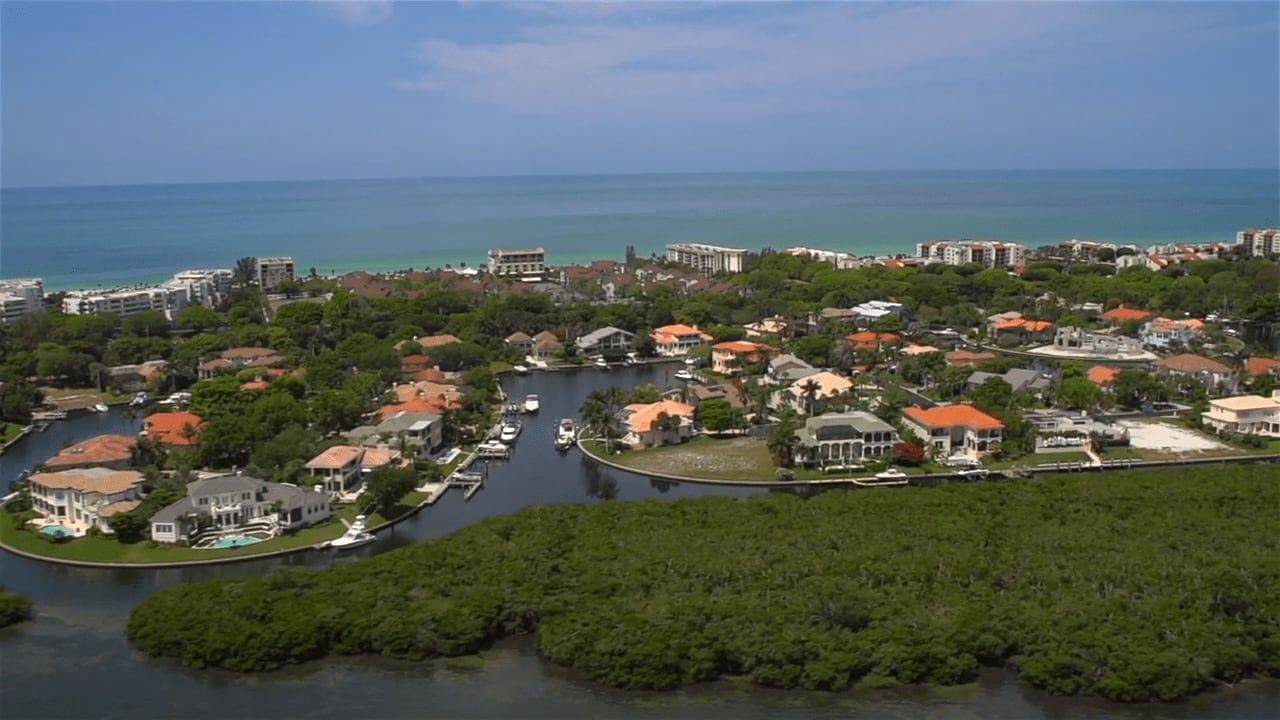 A coastal community in Bay Isles Harbor with rows of houses and a beach