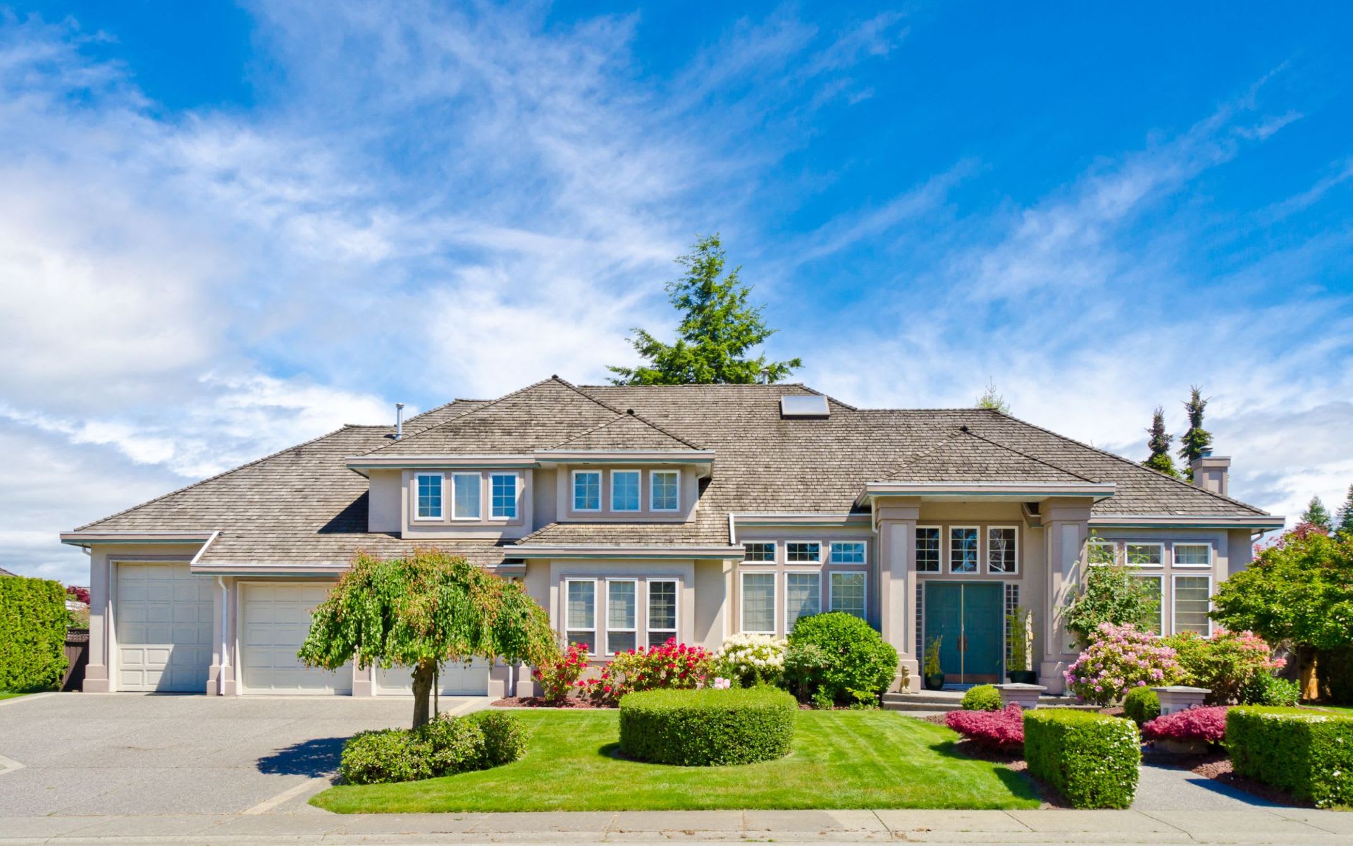 A large, spacious house with a lush green yard