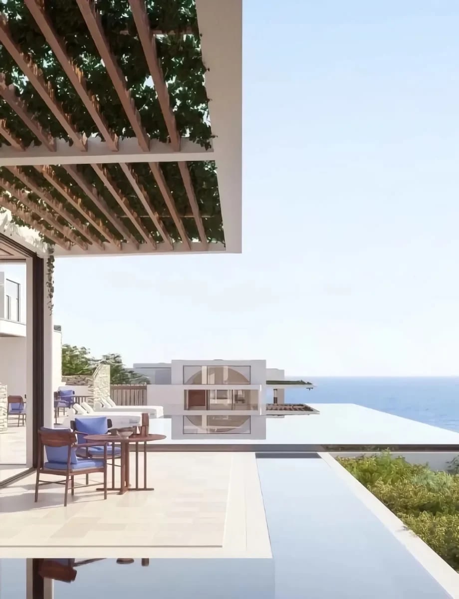 A luxurious outdoor terrace with a vine-covered pergola overlooking a stunning ocean view