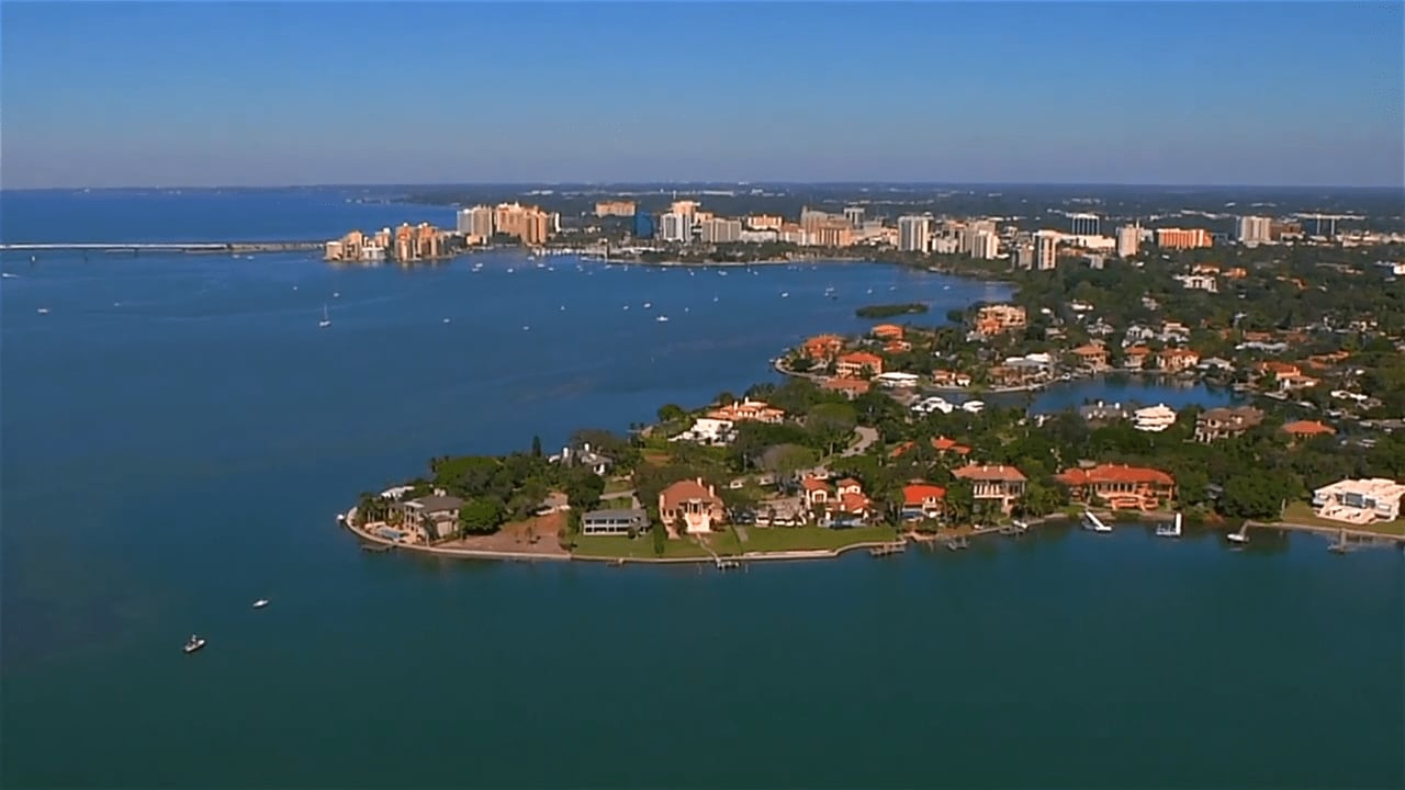 Aerial view of Harbor Acres with beachfront houses and high-rise buildings