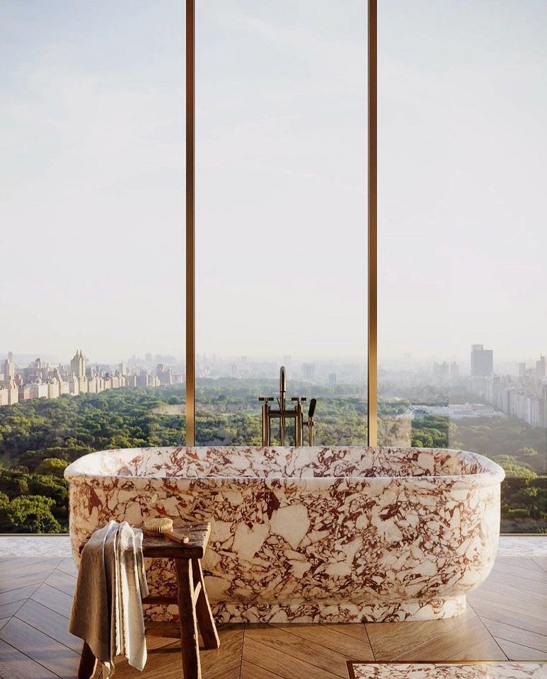 A bathtub in a bathroom with a view of the city