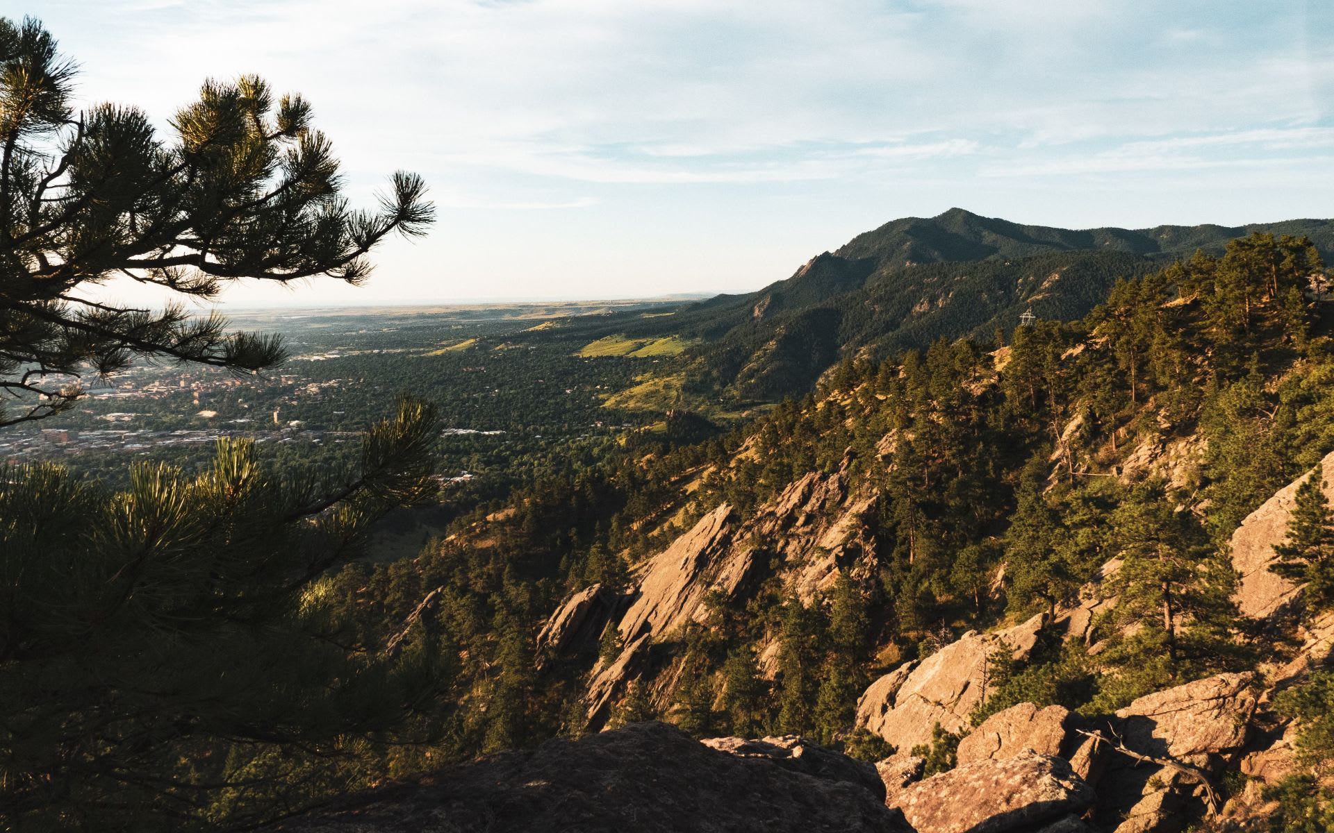 The Rocky Mountains landscape with lush greenery and valleys in a vibrant city.